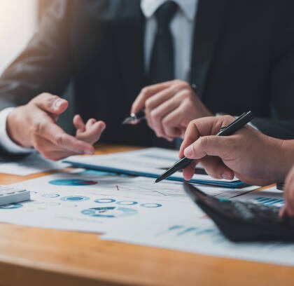 business people doing calculations analyze the work at the meeting